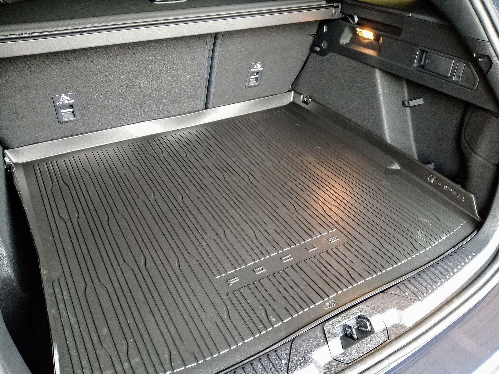 A moulded rubber cargo liner with raised edges fitted in an estate car's boot