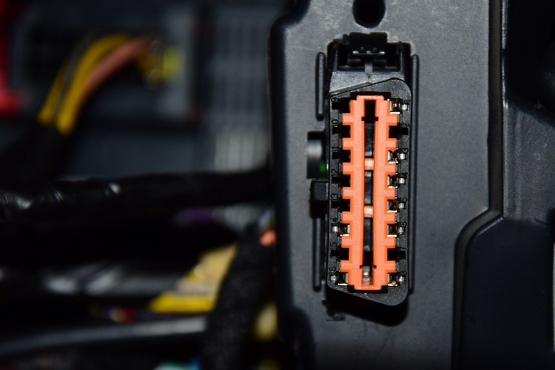 The 16-pin OBD2 diagnostic socket under a car's dashboard