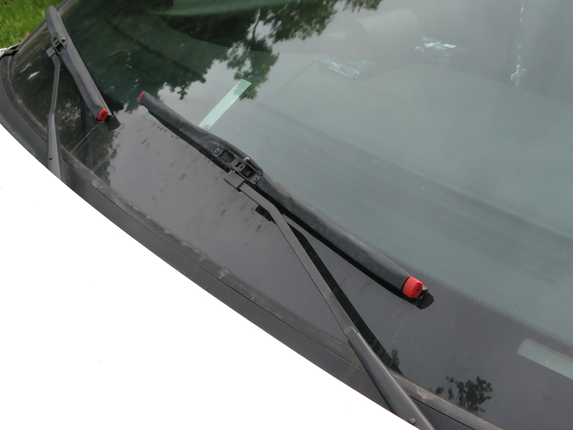 Beam-style wiper blades resting on a car windscreen