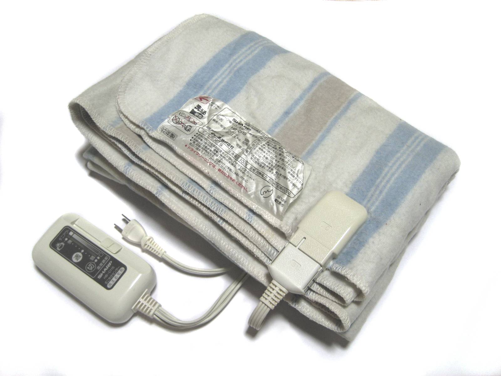 A folded striped electric blanket with its plug-in controller and cable