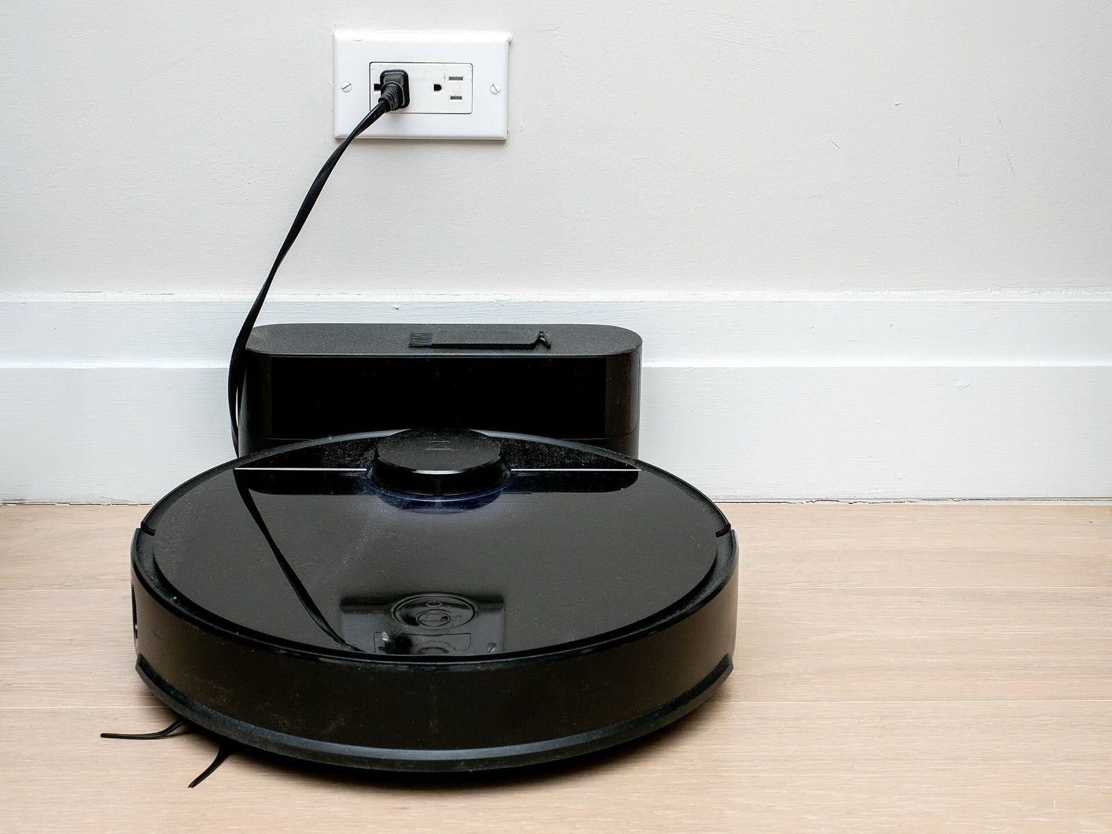 Robot vacuum with a LiDAR turret parked on its charging dock