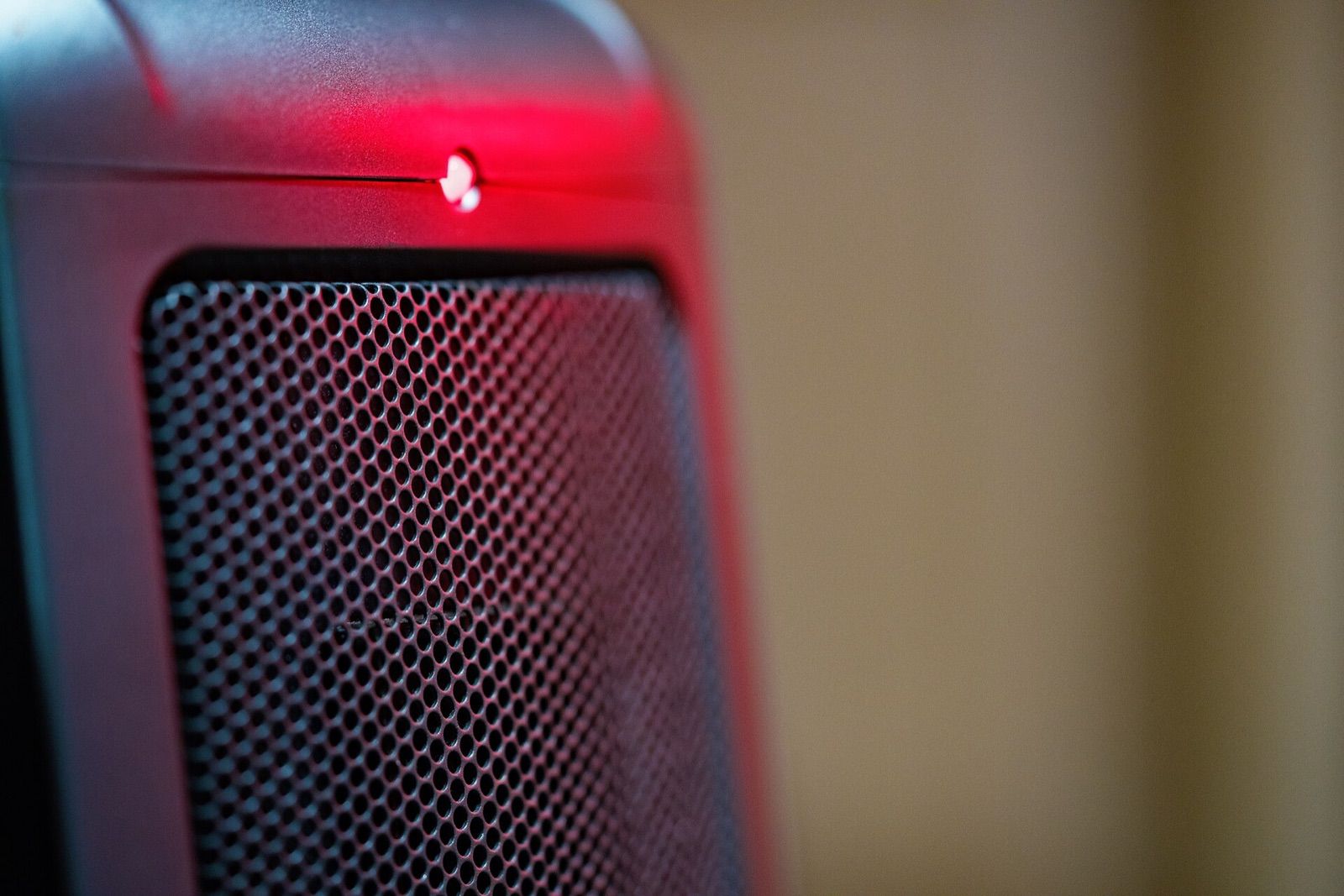 Close-up of a small ceramic space heater with its power light on