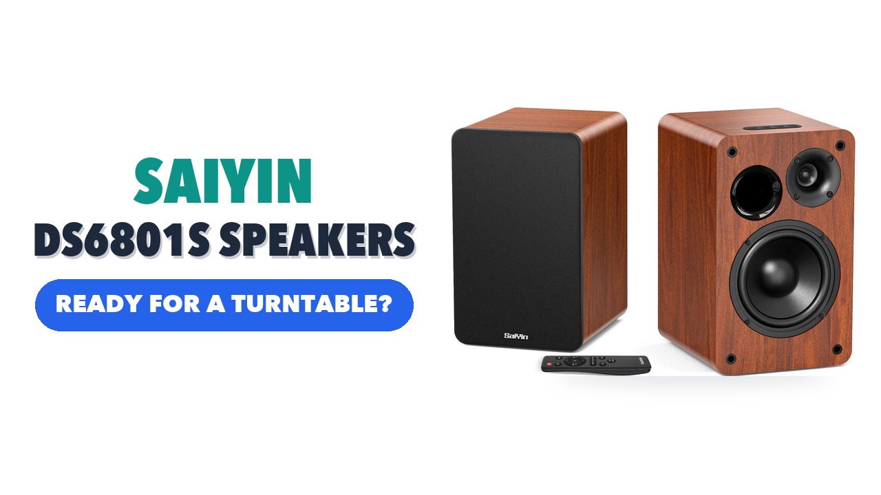 Pair of Saiyin DS6801S wood-grain bookshelf speakers, one with its grille on and one showing the drivers, with a remote