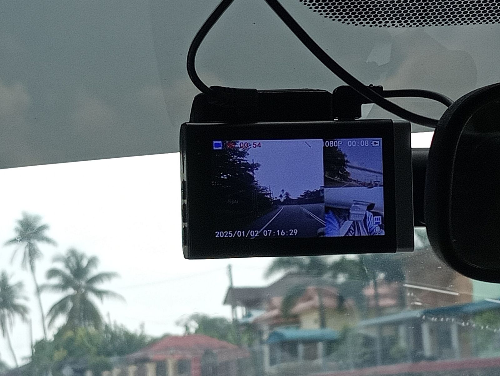 Dash cam mounted on a windscreen showing front and cabin views