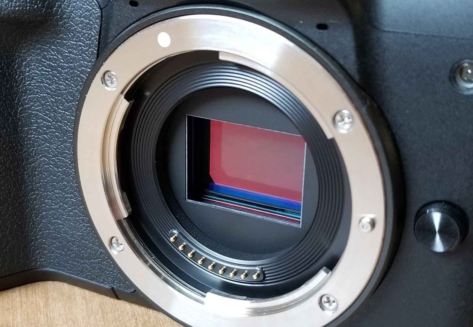 The image sensor of a mirrorless camera seen through its open lens mount