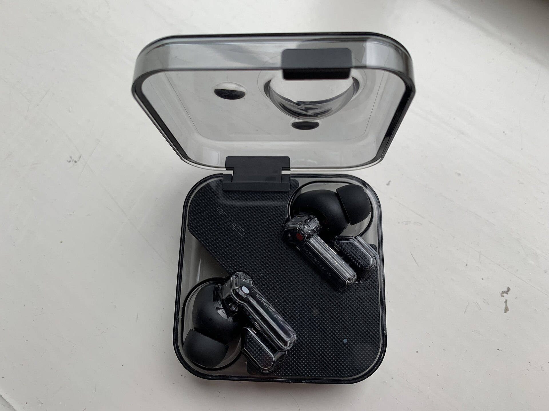 True wireless earbuds sitting in an open charging case