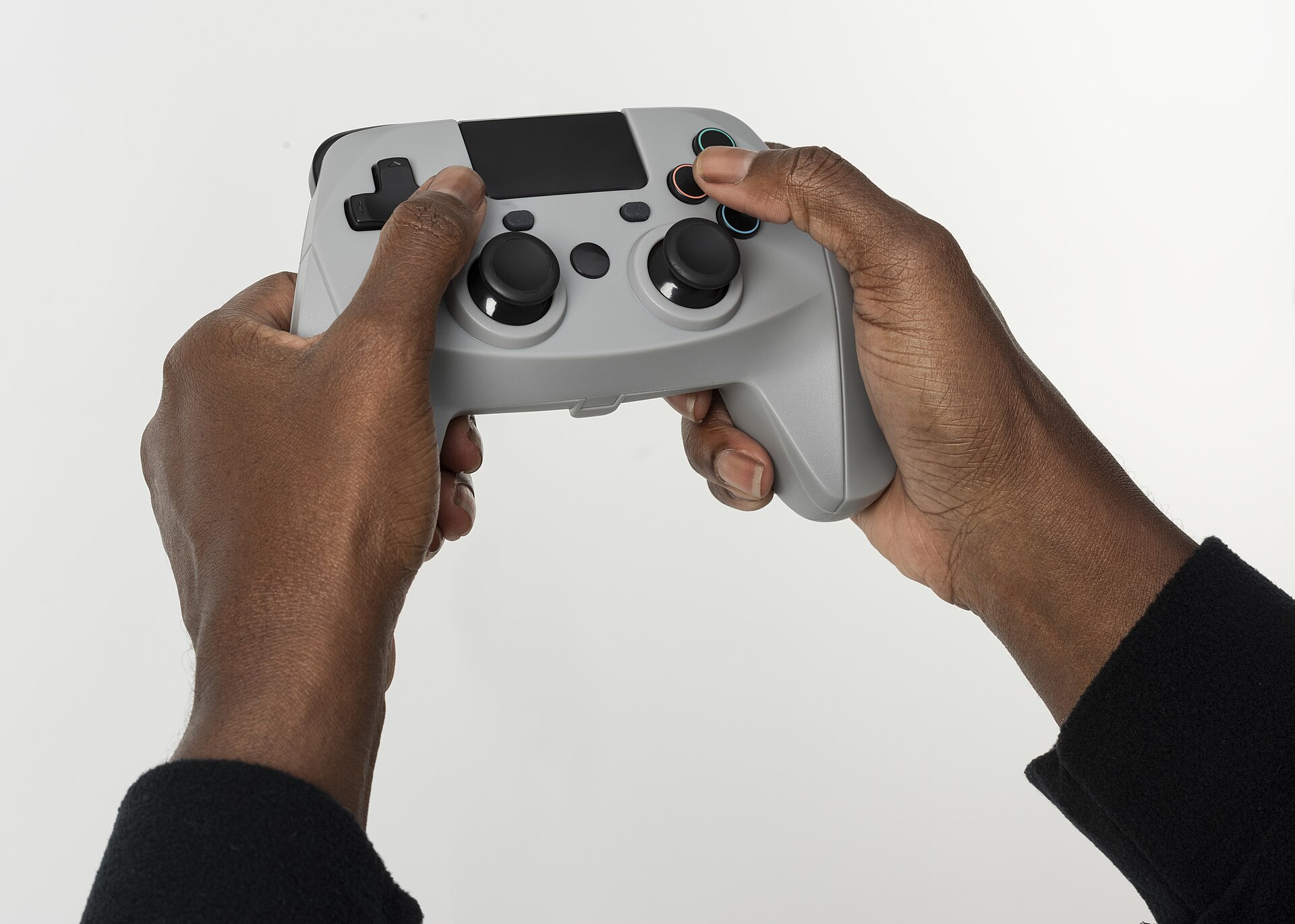 Hands holding a grey video game controller