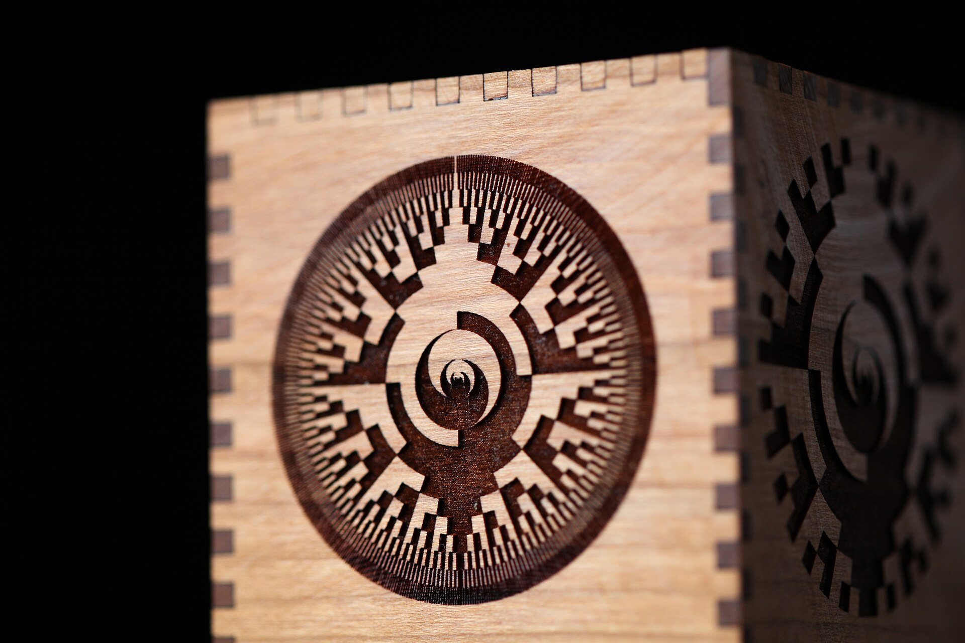 A wooden box with finger joints and a detailed laser-engraved pattern