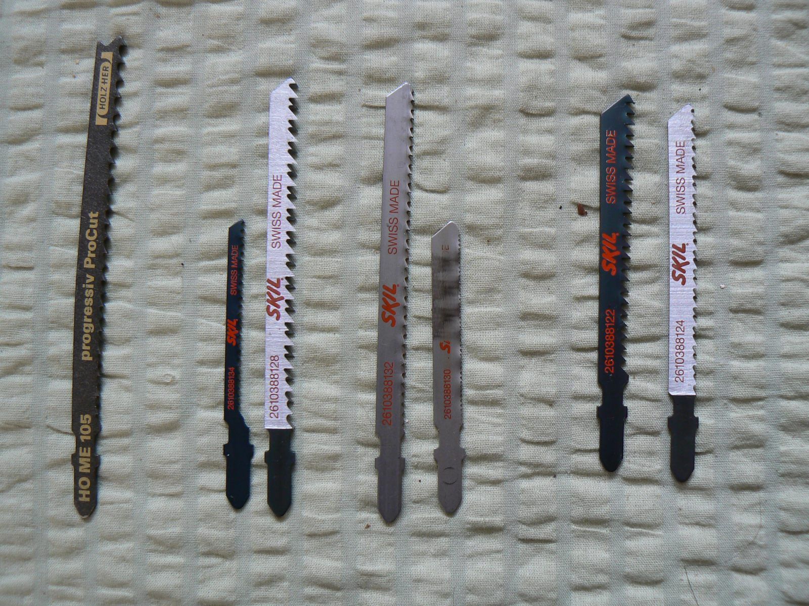 An assortment of T-shank jigsaw blades with different tooth patterns