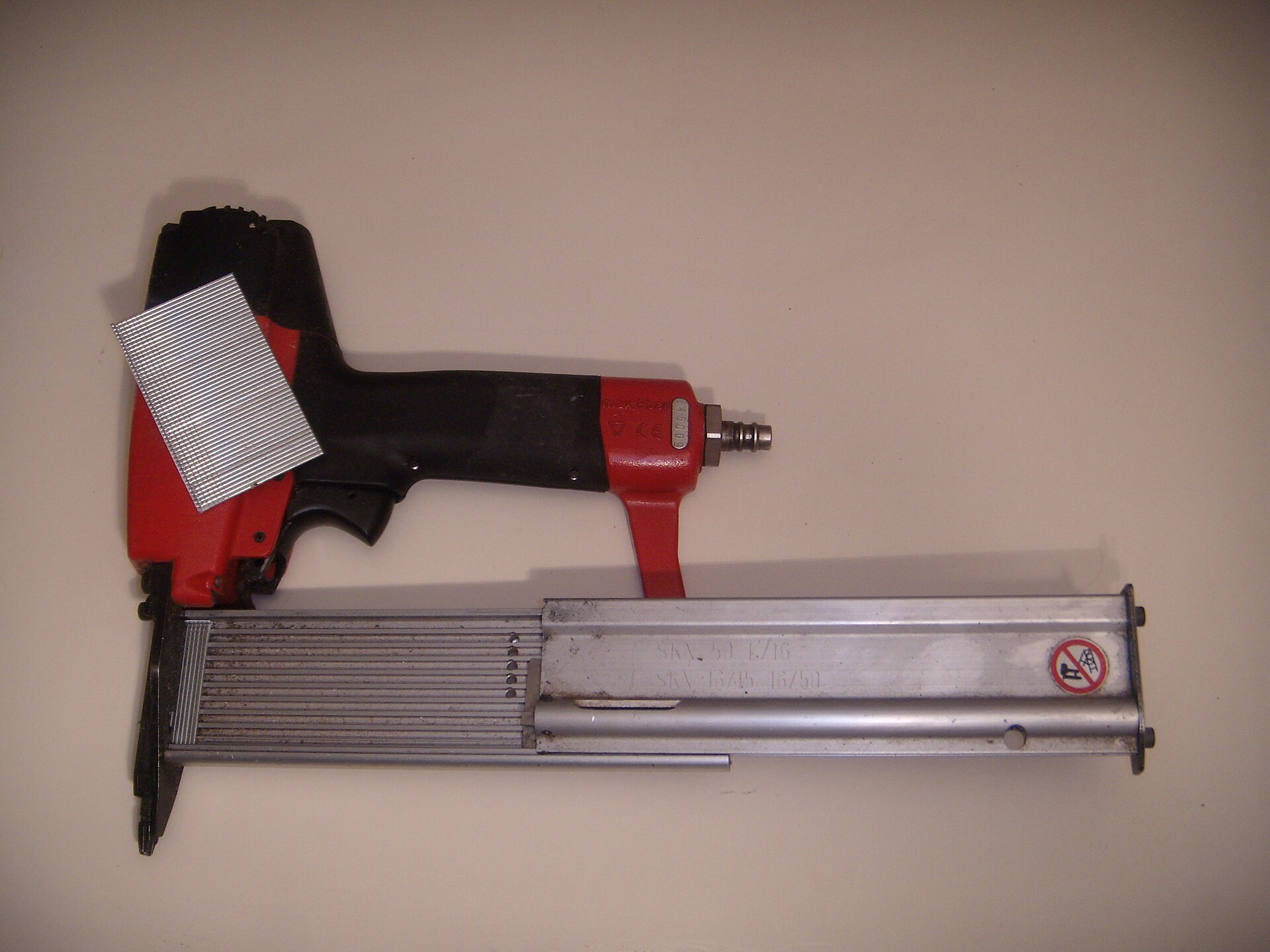 A pneumatic nailer with a strip of collated nails