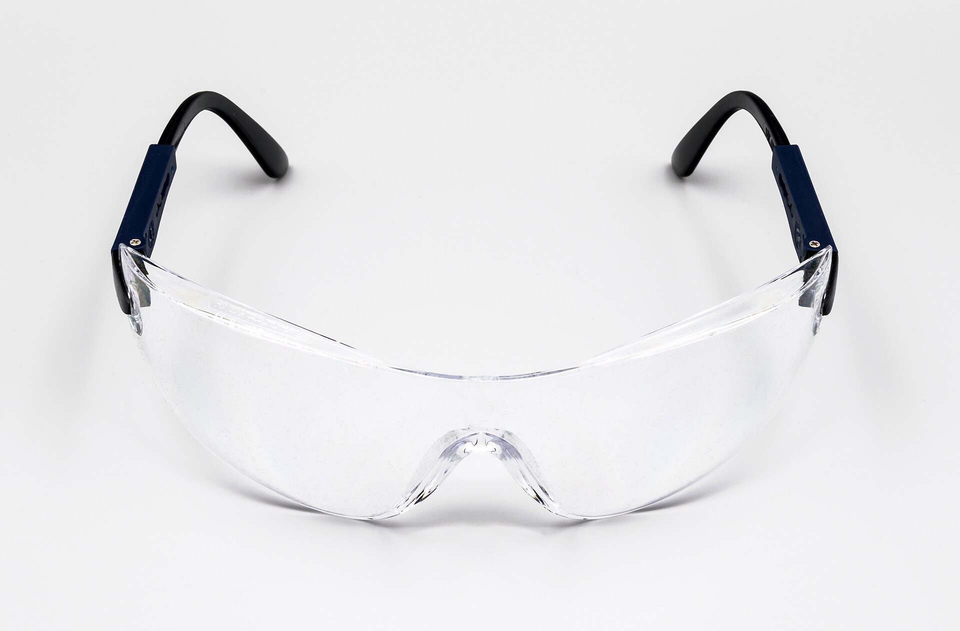 A pair of clear wraparound safety glasses with adjustable arms