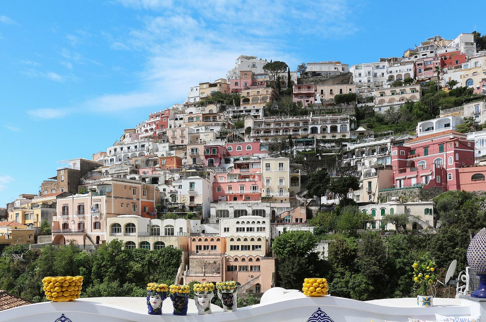 Pastel houses of Positano stacked on the hillside above the beach on the Amalfi Coast