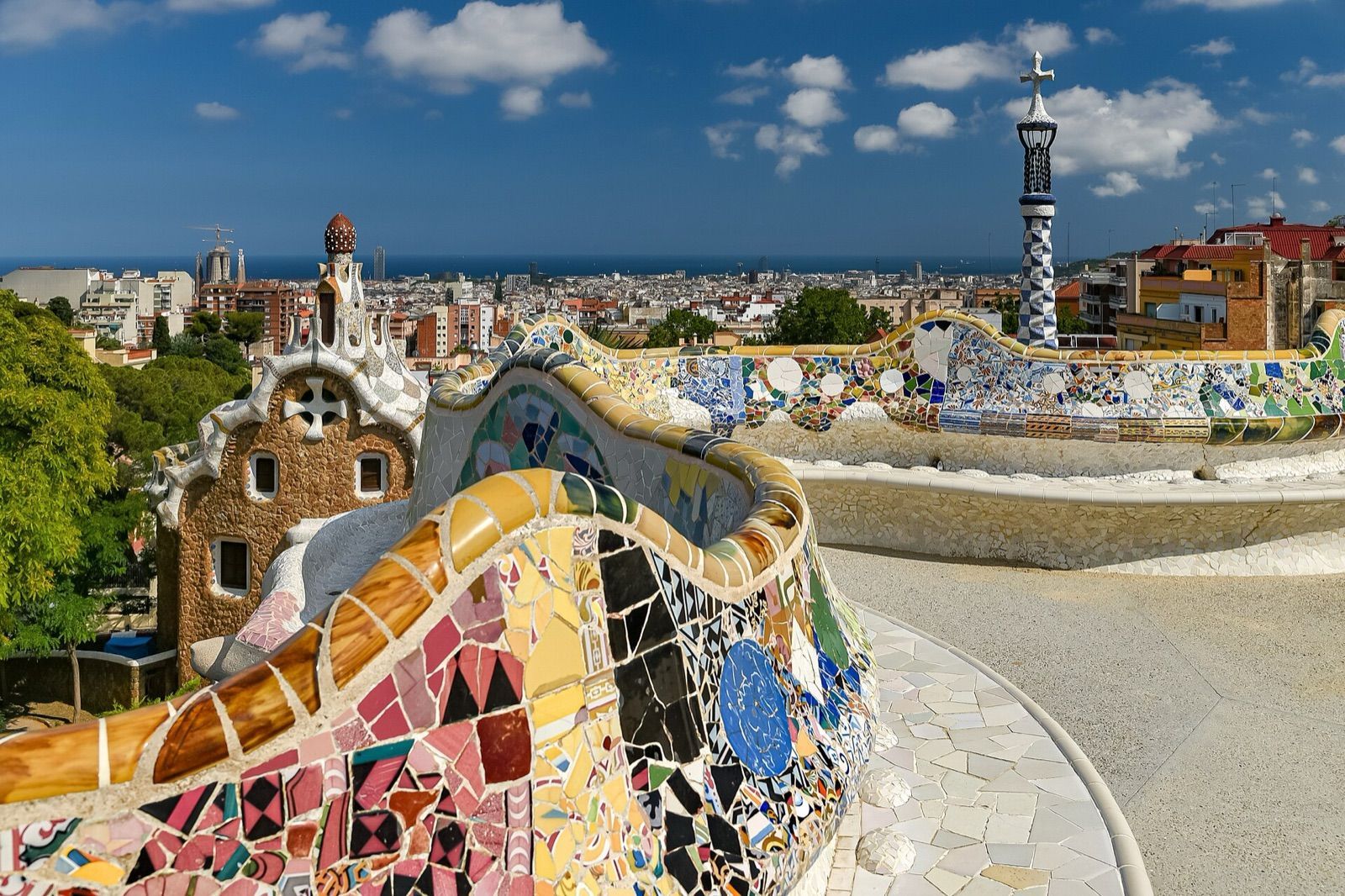 Mosaic-covered serpentine bench on the terrace of Park Güell overlooking Barcelona