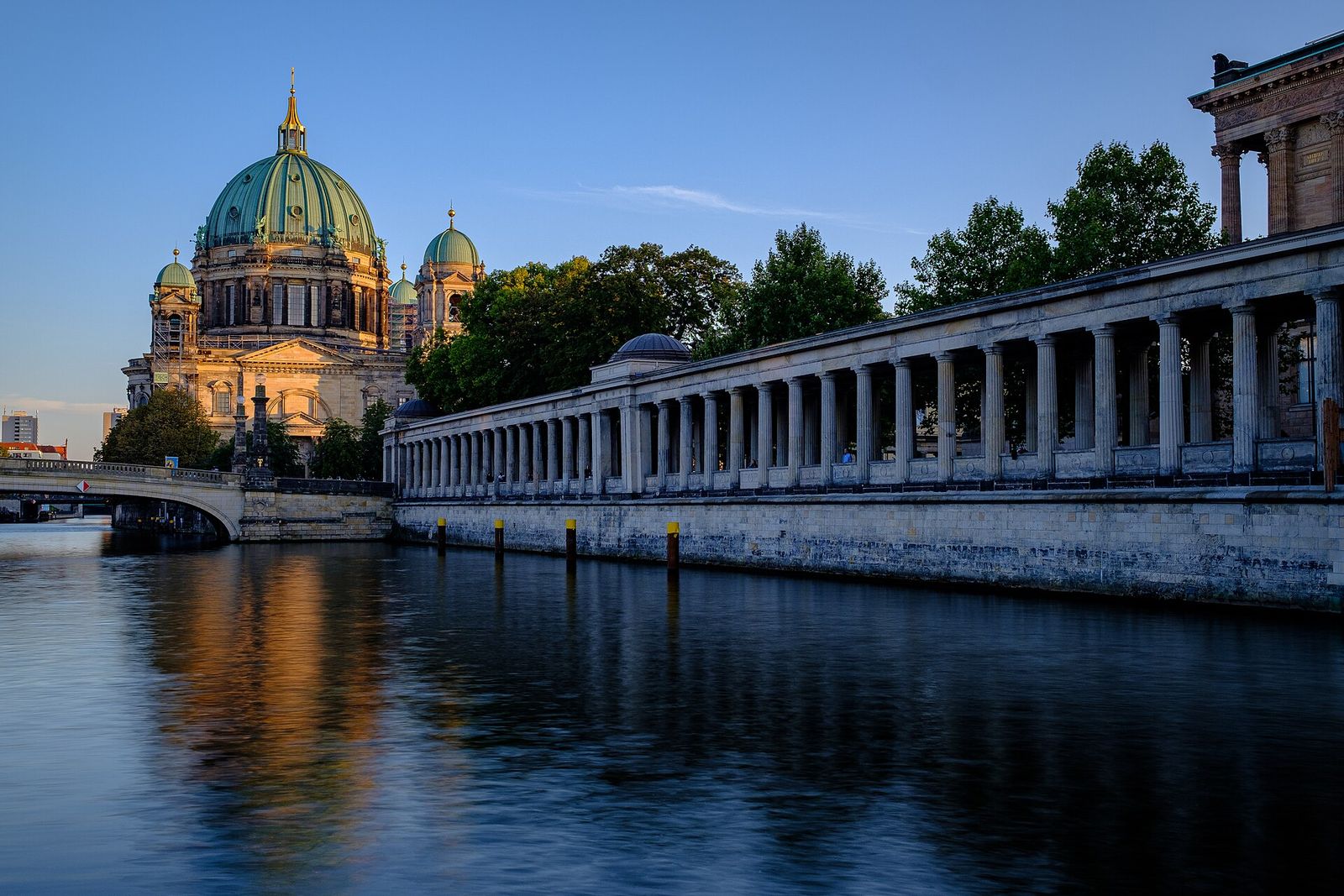 Berlin Cathedral and the colonnade of Museum Island reflected in the River Spree at dusk