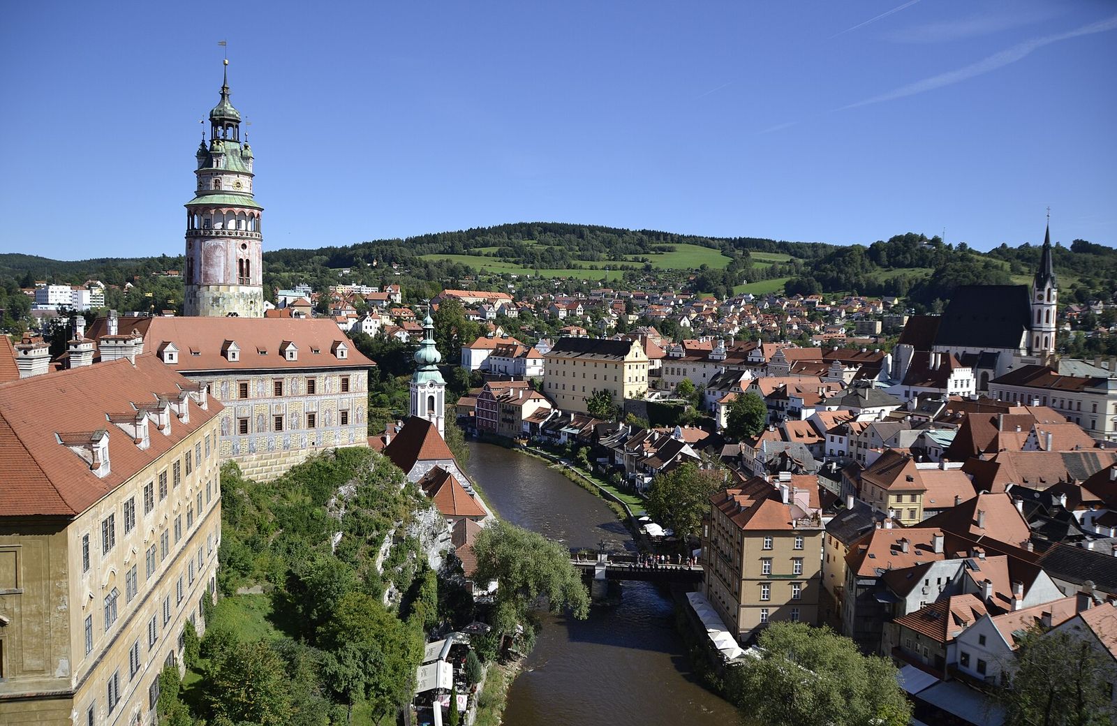 Red roofs of Český Krumlov's old town in a bend of the Vltava, below the castle tower