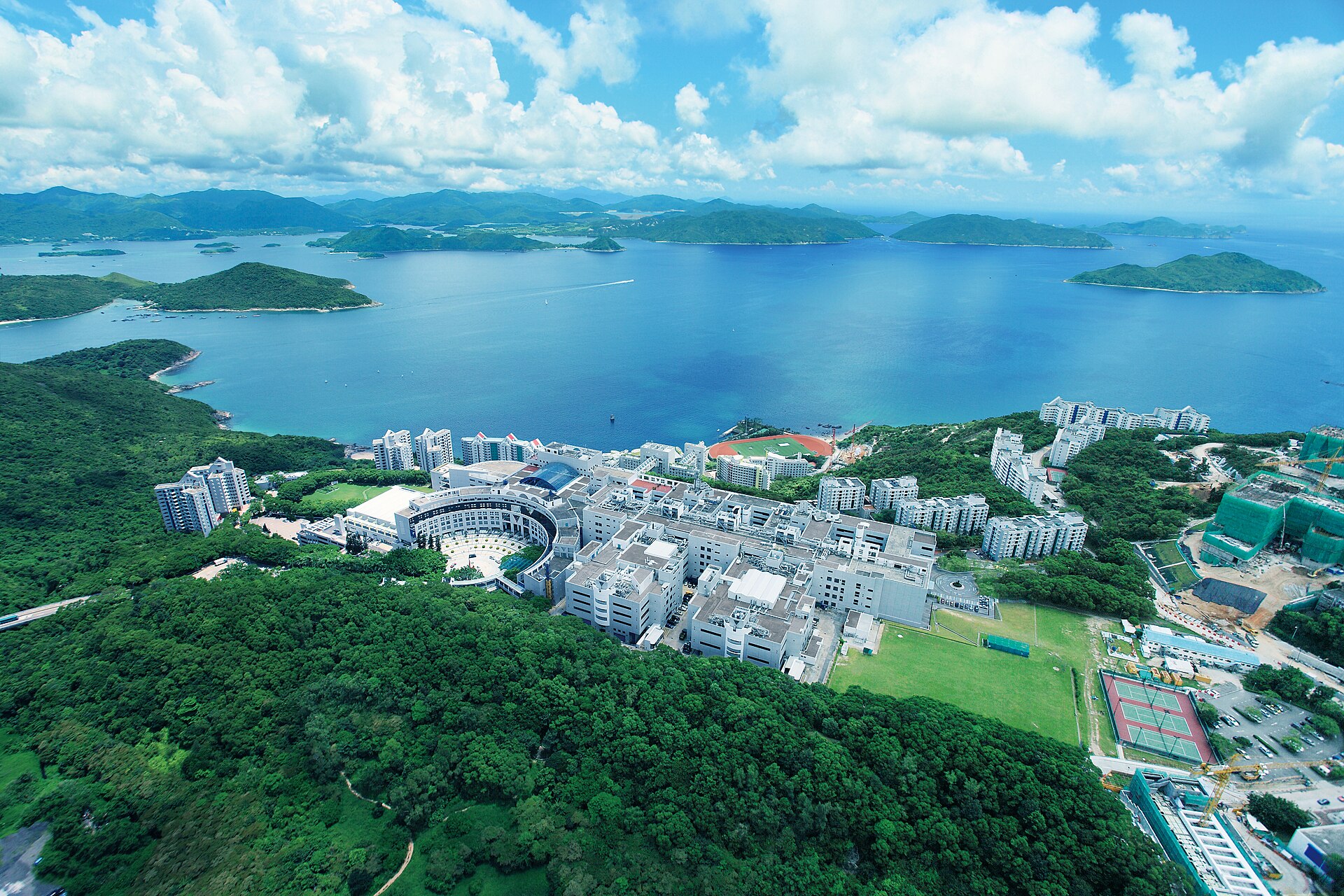 Aerial view of the HKUST campus on a green hillside above the sea at Clear Water Bay, Hong Kong