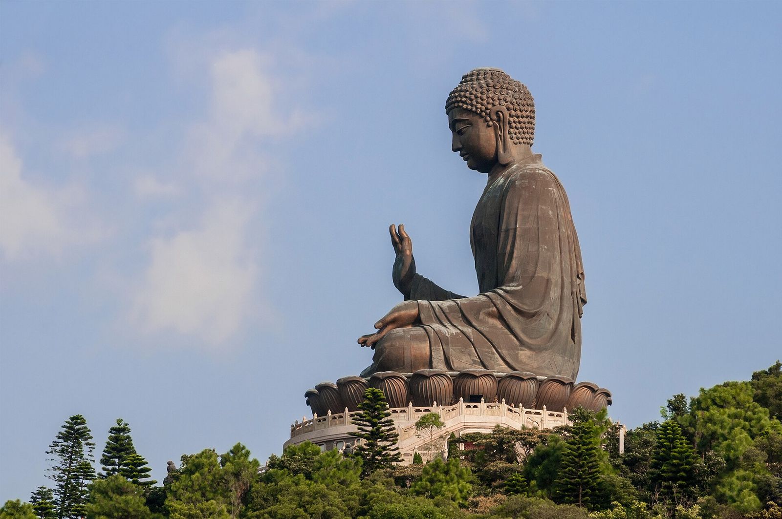 The bronze Tian Tan Buddha seated on its lotus throne above the trees of Ngong Ping on Lantau Island