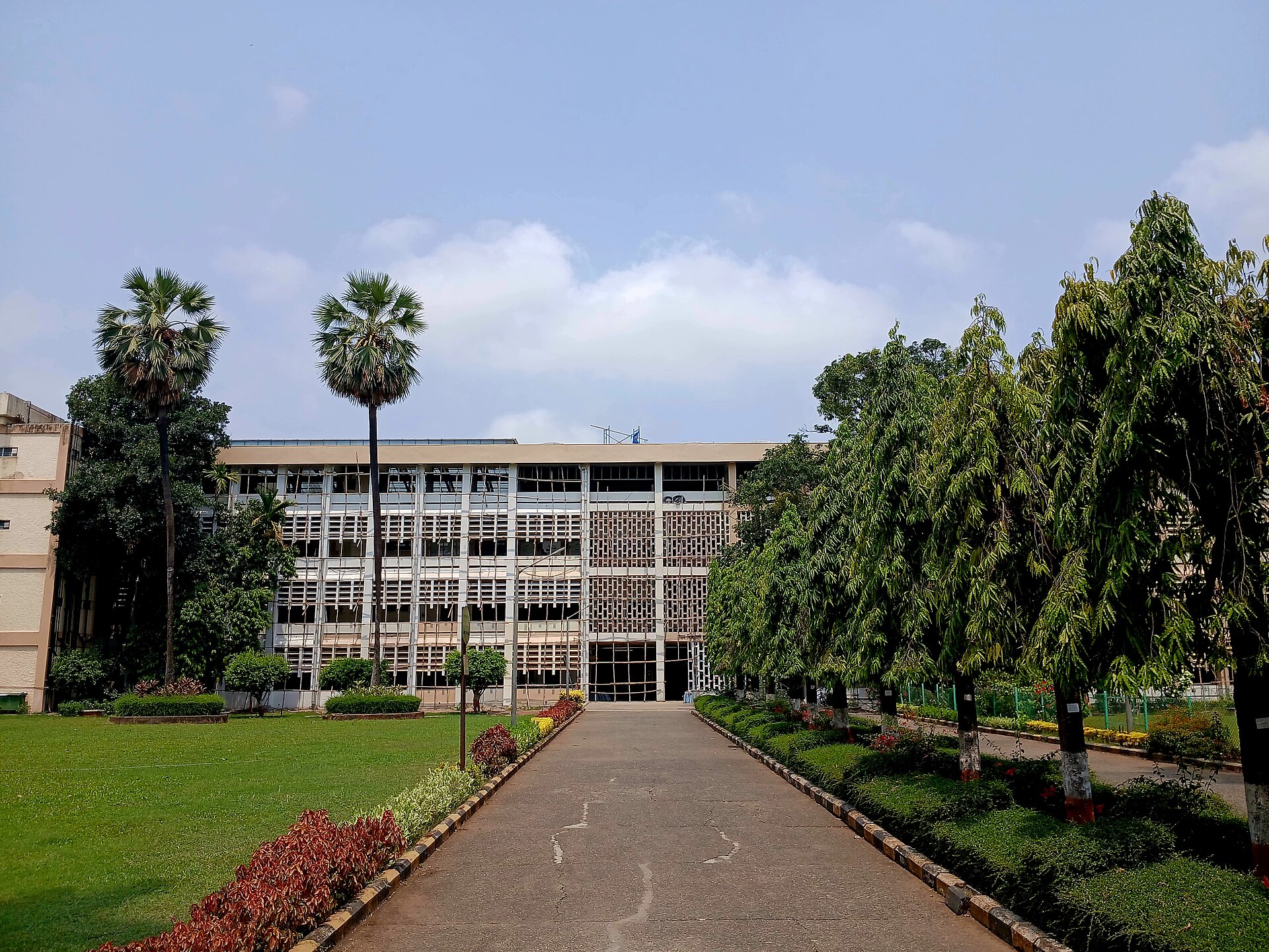 The Main Building of IIT Bombay at Powai, Mumbai, behind a lawn and an avenue of trees