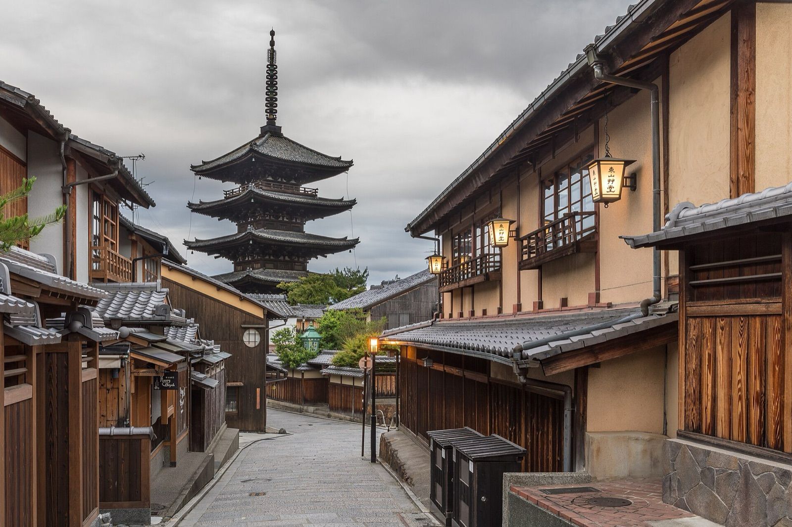 A quiet lantern-lit lane of wooden houses leading to the five-storey Yasaka pagoda in Kyoto's Higashiyama district