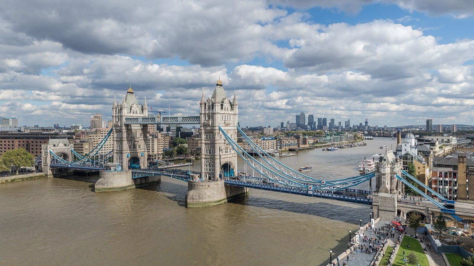 Tower Bridge spanning the River Thames in London under a cloudy sky