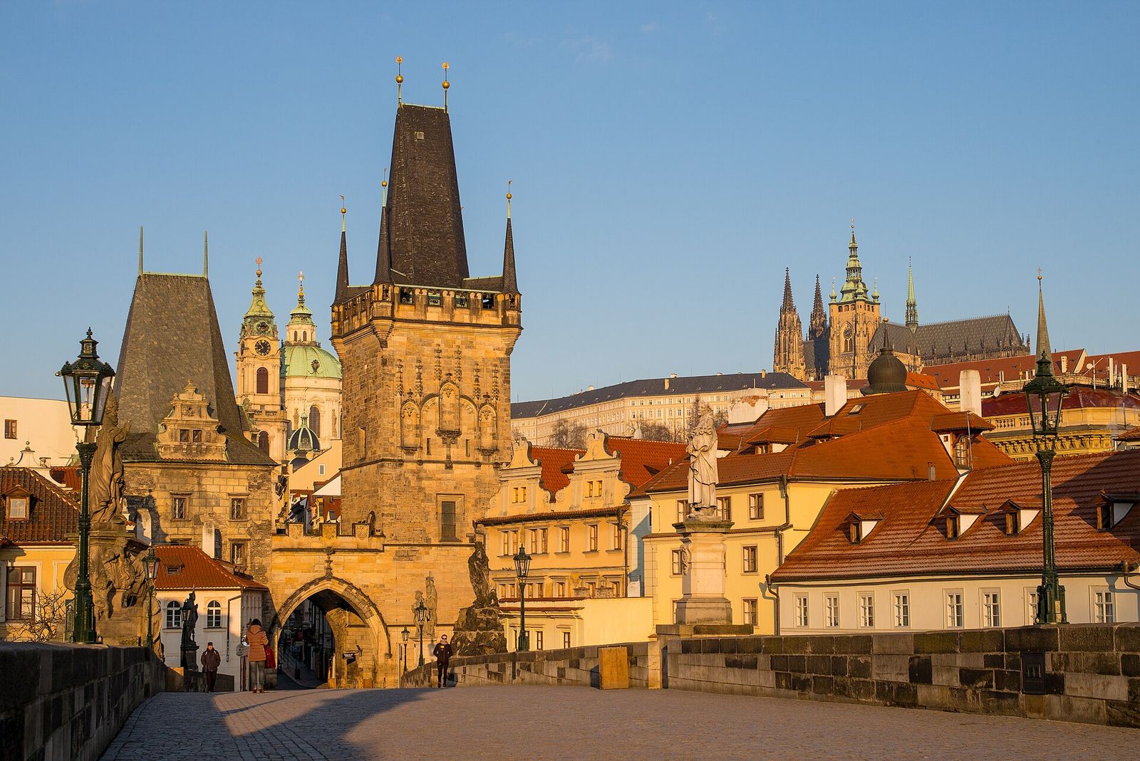 The Malá Strana bridge tower at the end of Charles Bridge in Prague, lit by early-morning sun