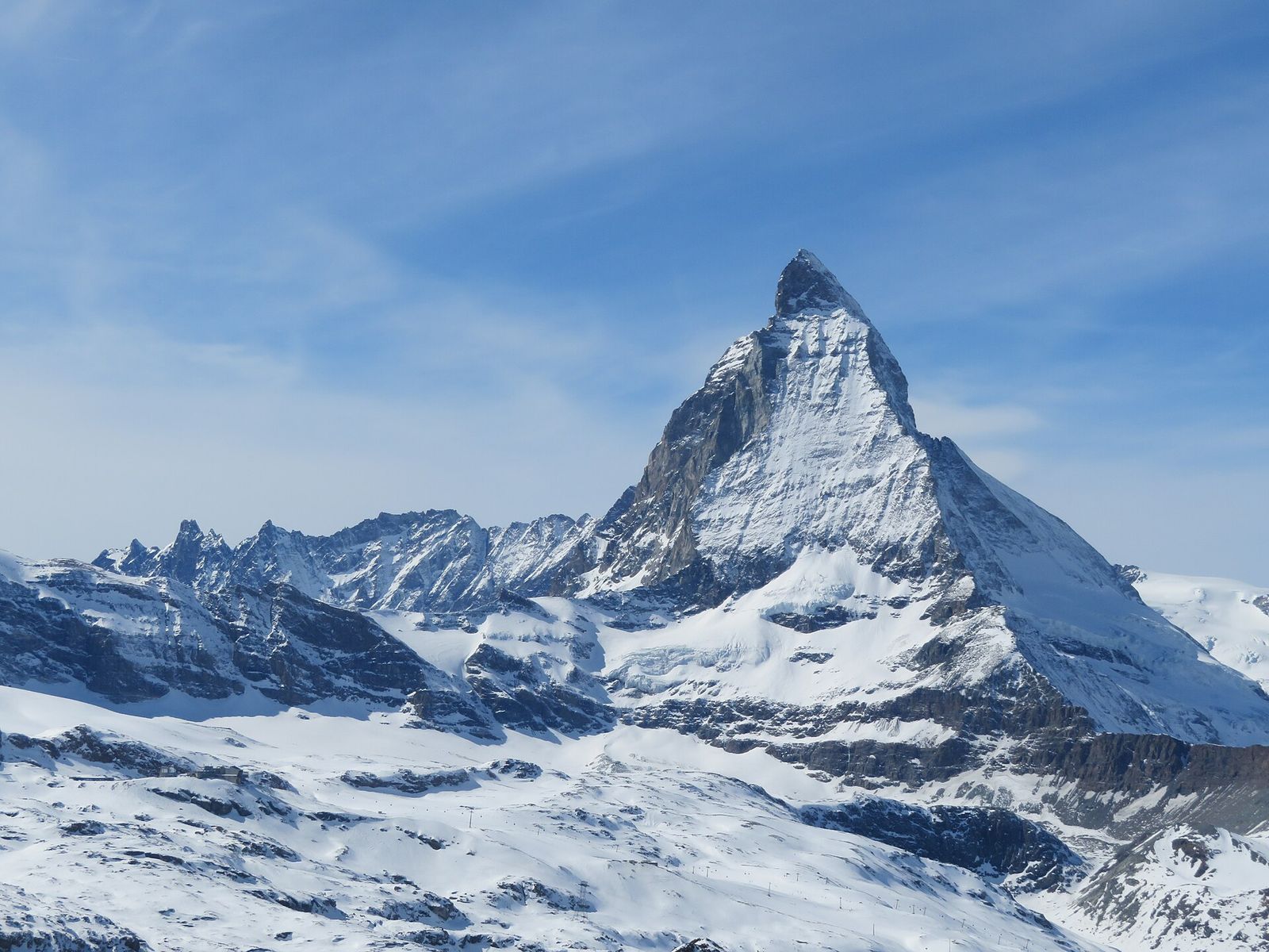 The snow-covered pyramid of the Matterhorn under a blue sky, seen from the Gornergrat above Zermatt