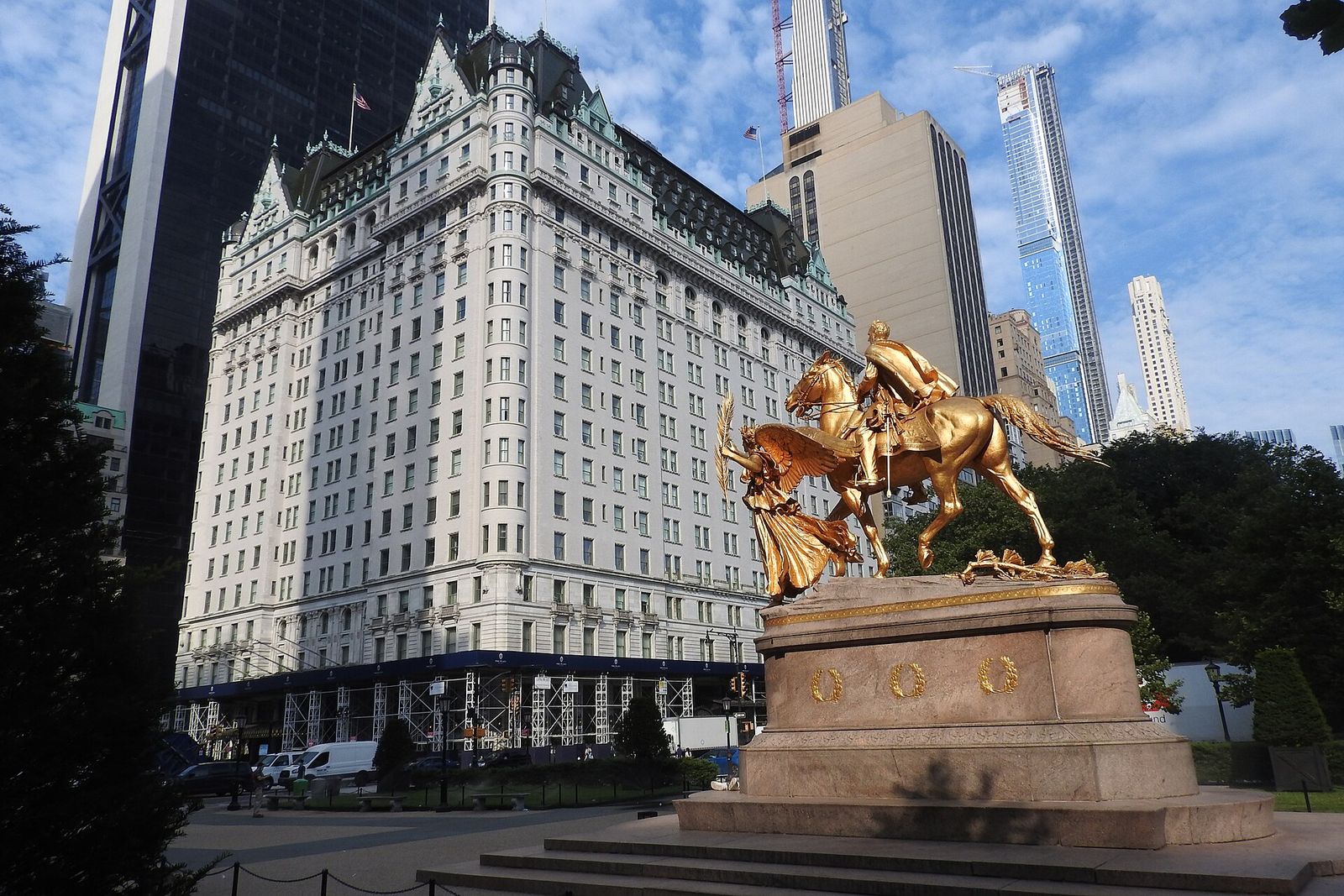 The white, château-style Plaza hotel rising behind the gilded Sherman statue at Grand Army Plaza