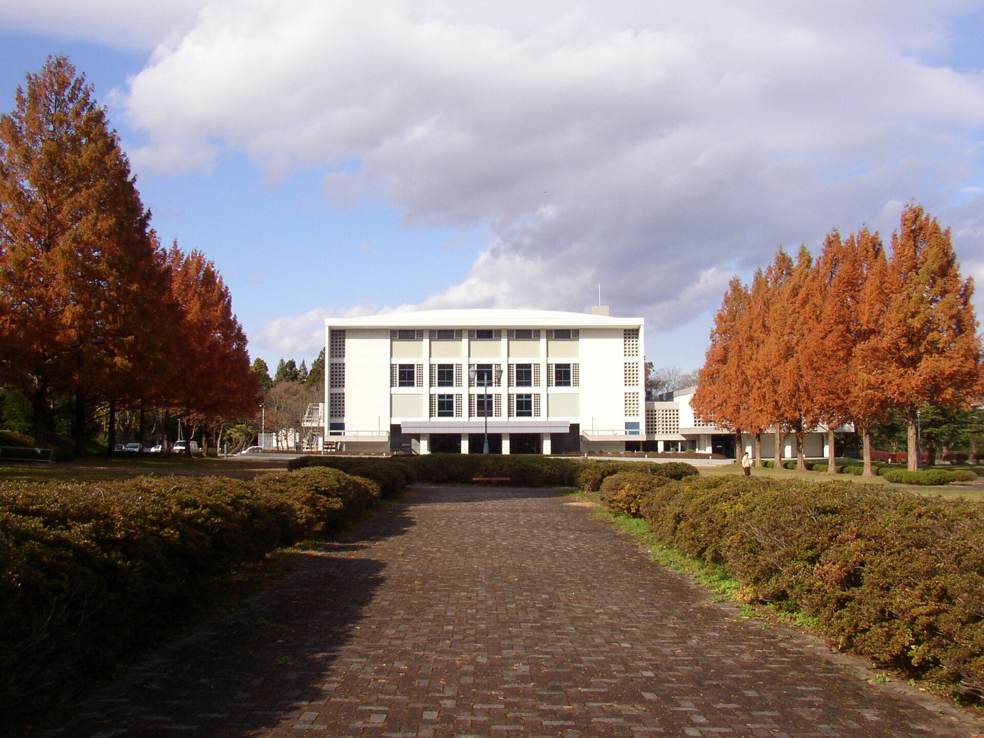 Tohoku University's Centennial Hall on the Kawauchi campus in Sendai, framed by autumn trees