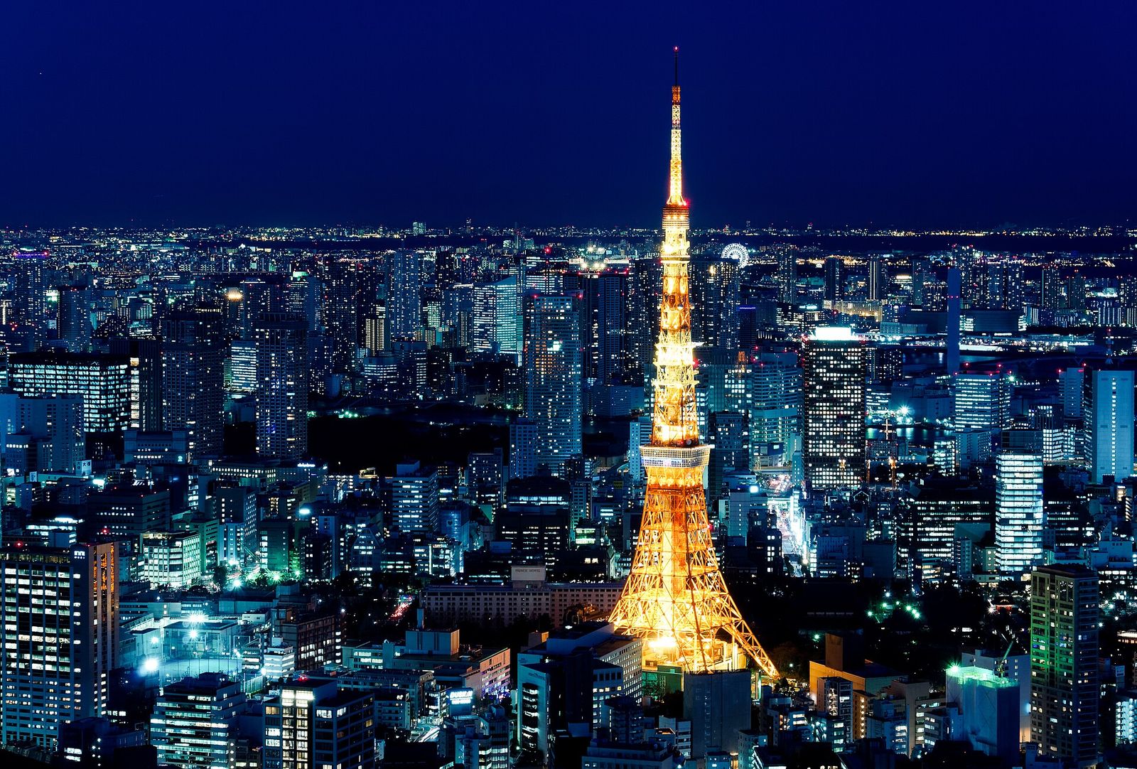 Tokyo Tower lit up in orange and white against the night sky