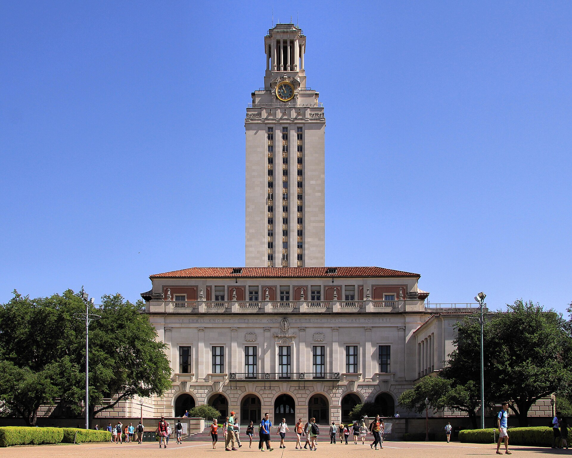 The Tower and Main Building of the University of Texas at Austin under a blue sky