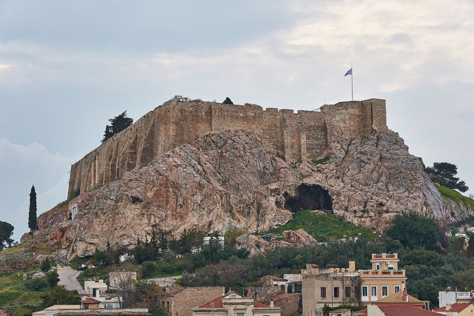 The Acropolis rock and its walls rising above the rooftops of Plaka in Athens