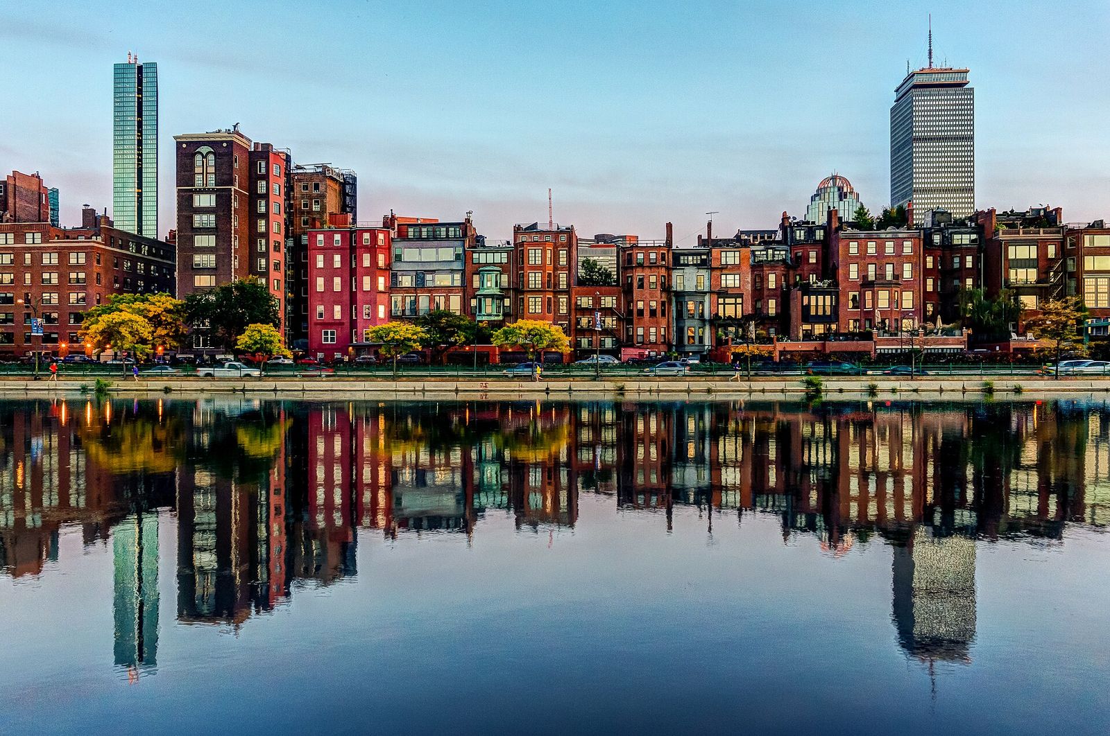 Back Bay brownstones and towers reflected in the still Charles River in Boston