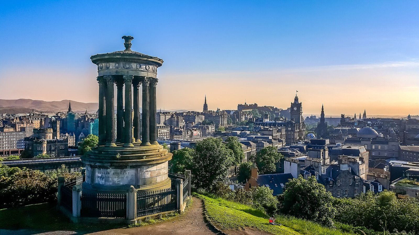 Edinburgh skyline at dusk from Calton Hill, with the Dugald Stewart Monument and the castle on the horizon