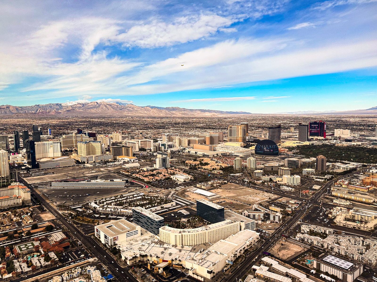 Aerial view across Las Vegas towards the resort towers of the Strip and the mountains to the west