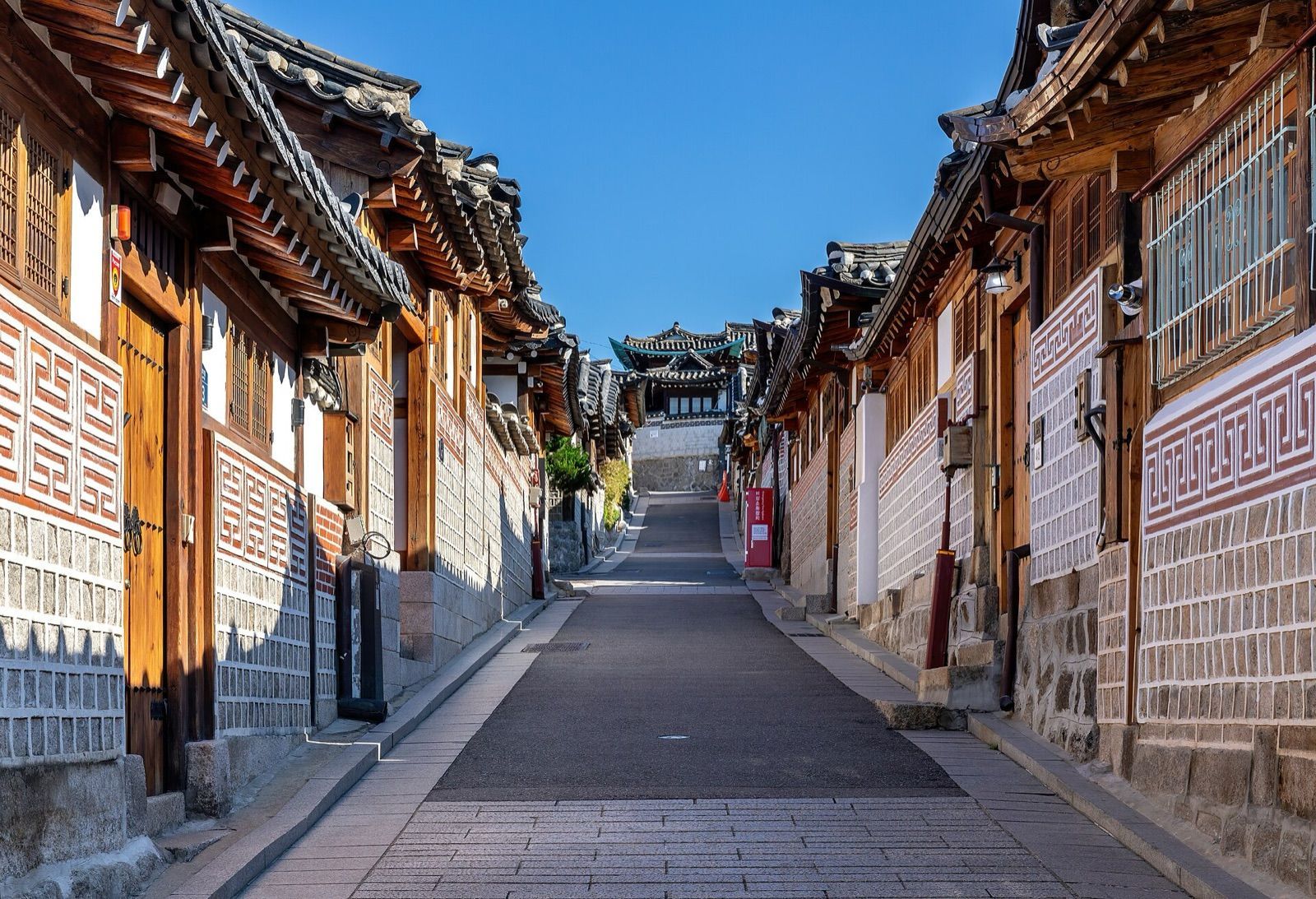 A sloping lane lined with traditional hanok houses in Bukchon Hanok Village, Seoul